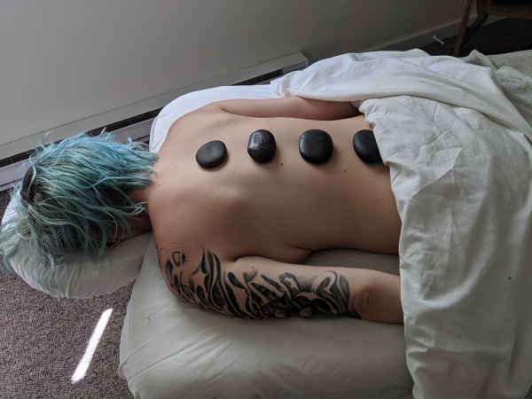 Photo of Woman receiving a Hot Stone Massage